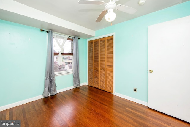 unfurnished bedroom featuring a closet, ceiling fan, and dark hardwood / wood-style flooring