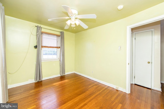 empty room with ceiling fan and dark wood-type flooring