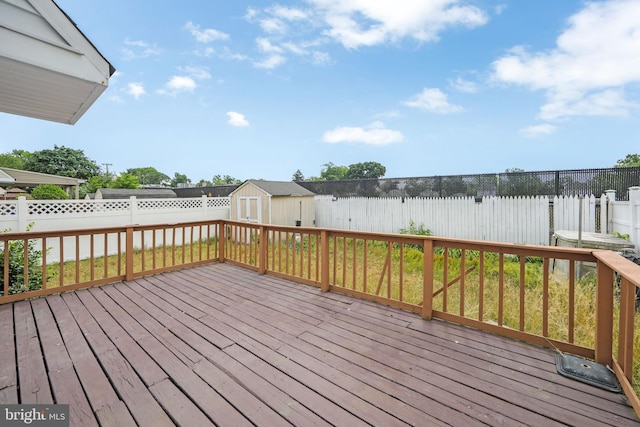 wooden terrace featuring a storage unit