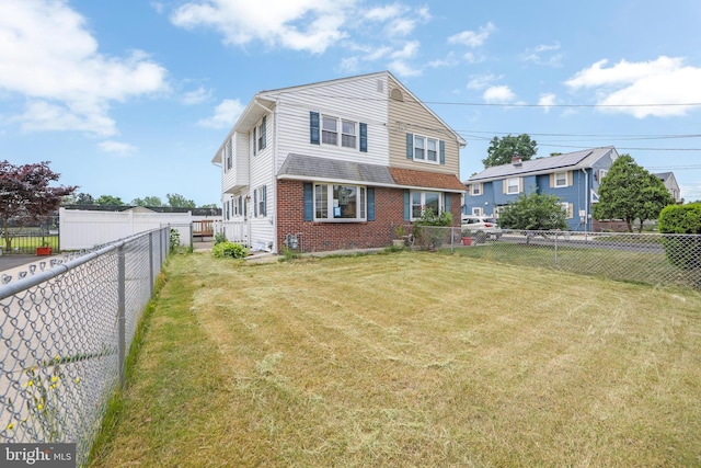 rear view of house with a yard