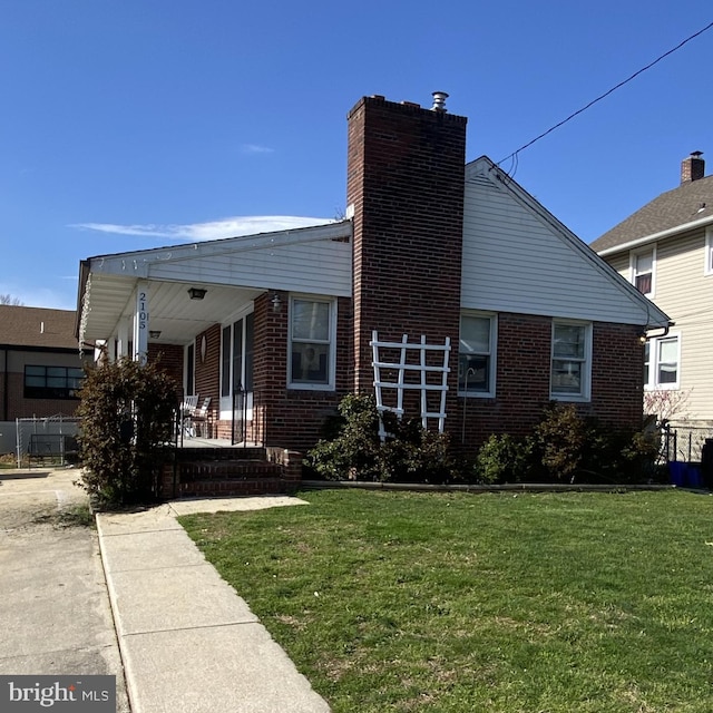 view of front facade with a front yard and covered porch