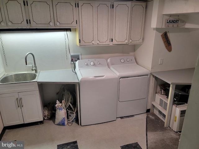 clothes washing area with cabinets, sink, washing machine and dryer, and hookup for a washing machine