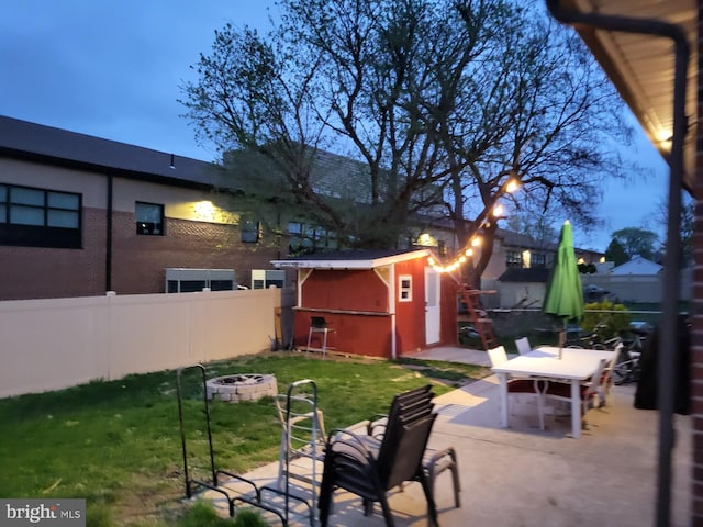 view of yard featuring a patio and a storage shed