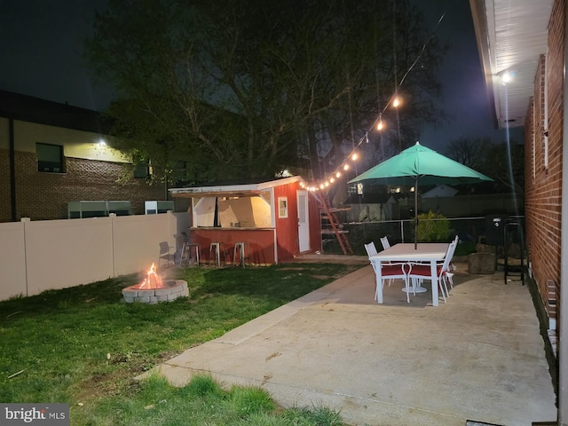 exterior space with a fire pit and a lawn