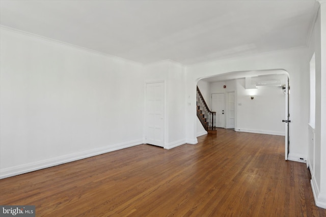 spare room featuring ornamental molding and dark wood-type flooring