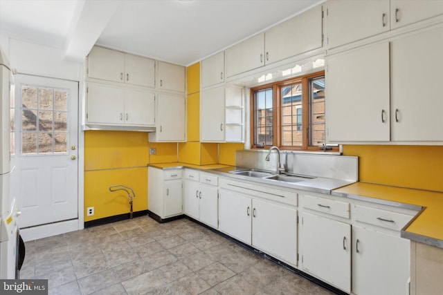 kitchen with sink, a wealth of natural light, and light tile floors