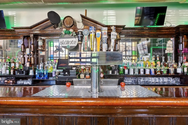 bar with dark brown cabinetry