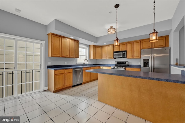 kitchen featuring sink, stainless steel appliances, light tile floors, and decorative light fixtures