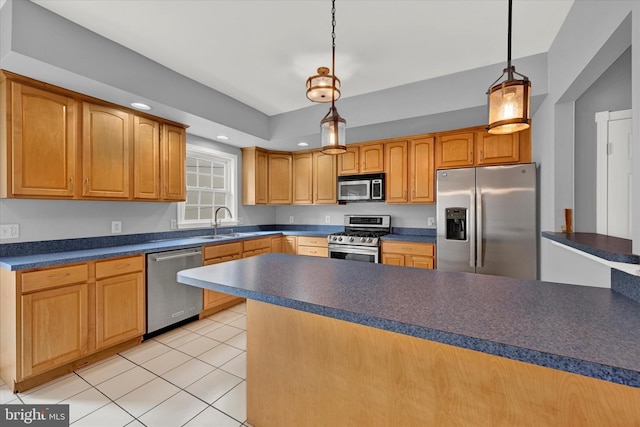 kitchen with hanging light fixtures, appliances with stainless steel finishes, light tile floors, and sink