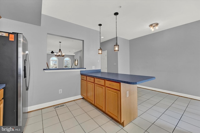 kitchen with a chandelier, stainless steel fridge with ice dispenser, pendant lighting, and light tile floors