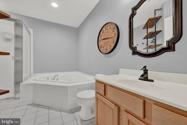 bathroom with tiled tub, lofted ceiling, toilet, tile floors, and vanity