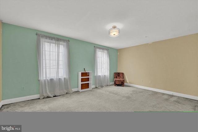 spare room featuring light colored carpet