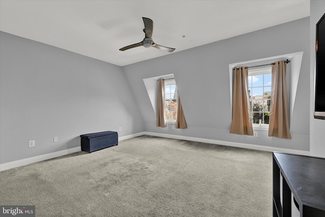 carpeted empty room featuring plenty of natural light and ceiling fan