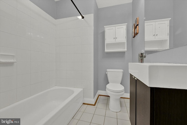 full bathroom with tiled shower / bath combo, toilet, tile floors, and vanity