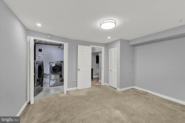 unfurnished bedroom featuring light colored carpet and separate washer and dryer