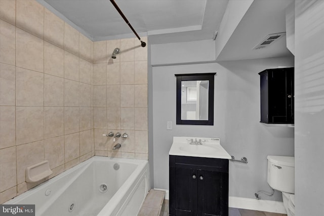 full bathroom with tile flooring, tiled shower / bath, vanity, and toilet