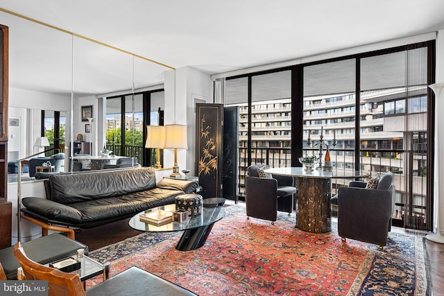 living room with floor to ceiling windows and dark hardwood / wood-style floors