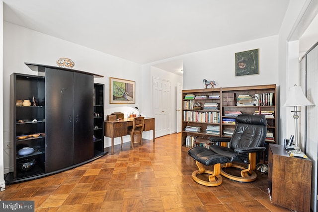 home office with light parquet flooring