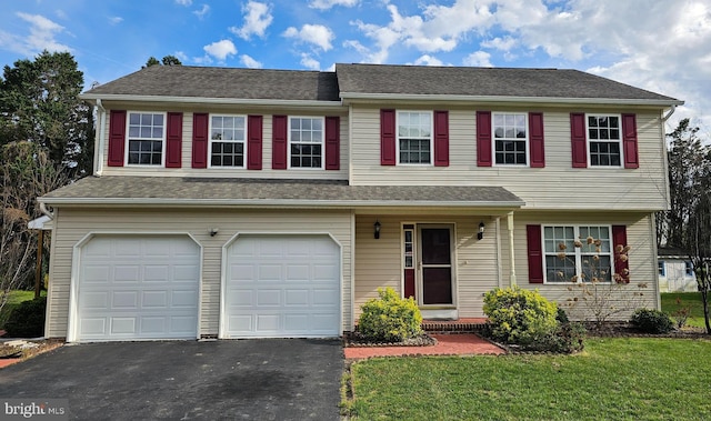 view of front of house with a front lawn and a garage