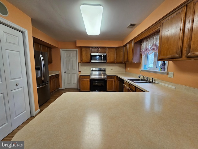 kitchen with sink, fridge with ice dispenser, black dishwasher, and range with electric cooktop