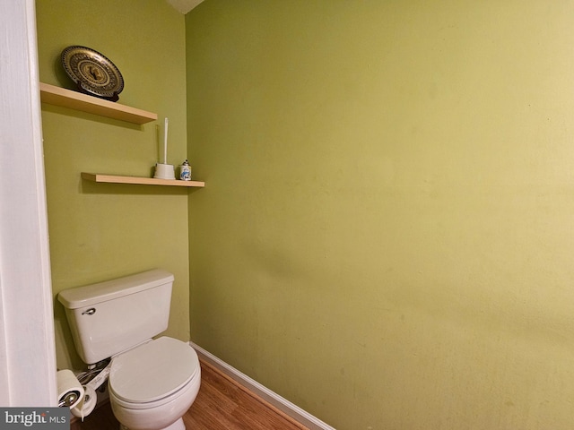 bathroom featuring toilet and wood-type flooring