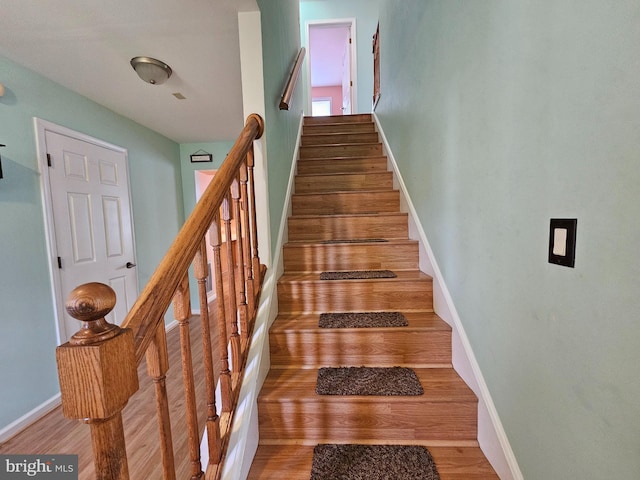 stairs with dark wood-type flooring