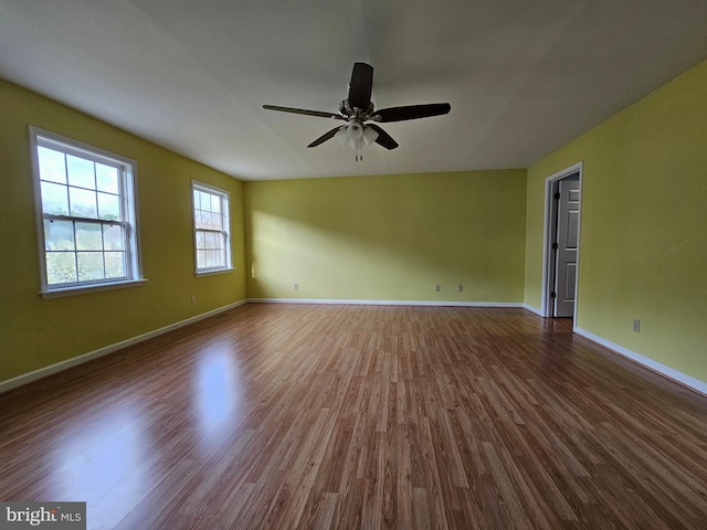 unfurnished room featuring ceiling fan and dark hardwood / wood-style floors