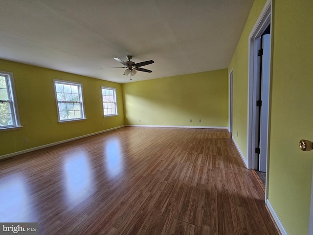 spare room with ceiling fan and dark wood-type flooring