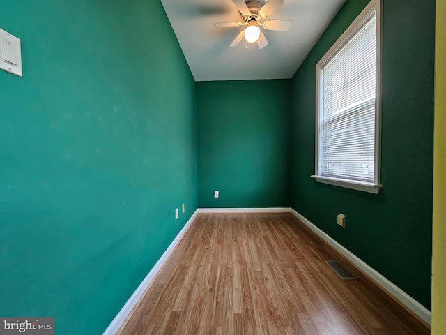 empty room with ceiling fan and wood-type flooring