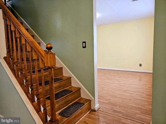 stairs with light wood-type flooring