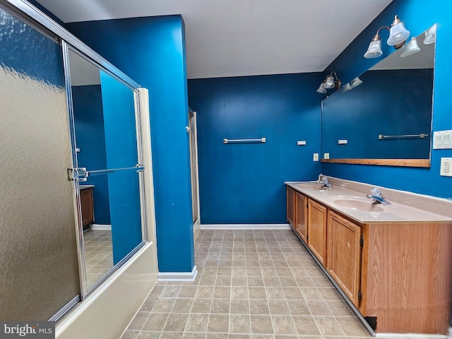 bathroom with tile flooring, double vanity, and bath / shower combo with glass door