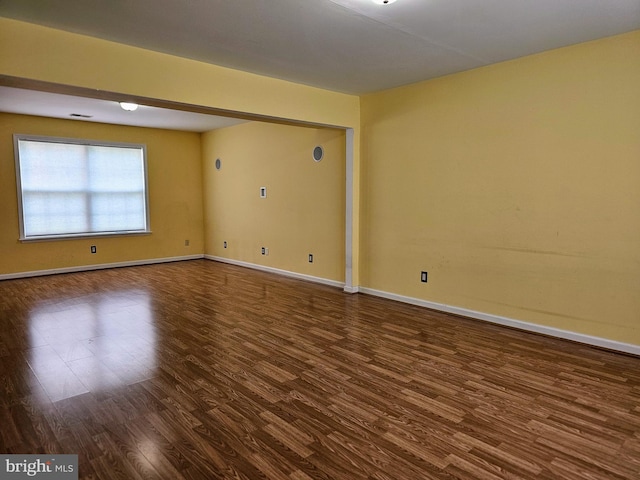 unfurnished room with dark hardwood / wood-style floors