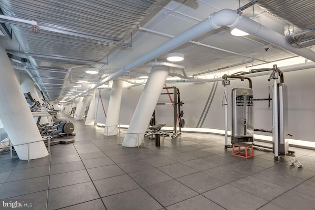 exercise room featuring dark tile floors