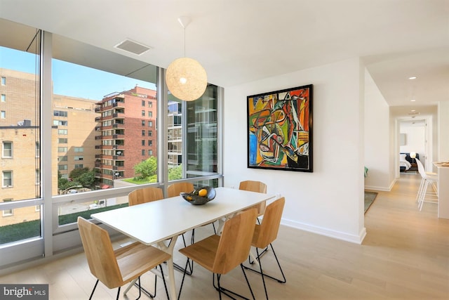 dining area featuring light wood-type flooring and a wealth of natural light