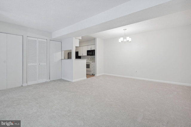 unfurnished living room featuring a textured ceiling, light carpet, and a notable chandelier