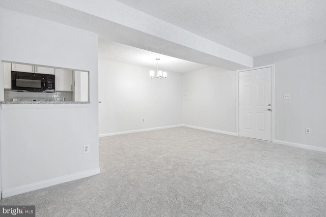 interior space with an inviting chandelier and a textured ceiling