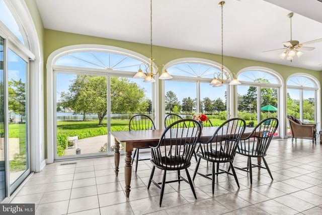 sunroom / solarium with ceiling fan with notable chandelier and plenty of natural light