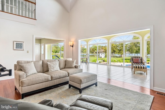 living room featuring hardwood / wood-style floors and a towering ceiling