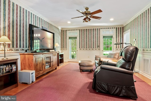 living room featuring crown molding and ceiling fan