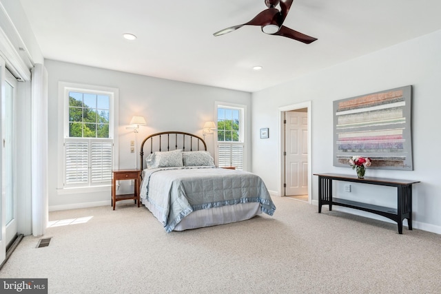 bedroom with ceiling fan and light carpet