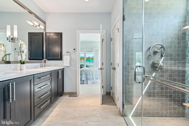 bathroom with vanity, tile patterned floors, and a shower with door