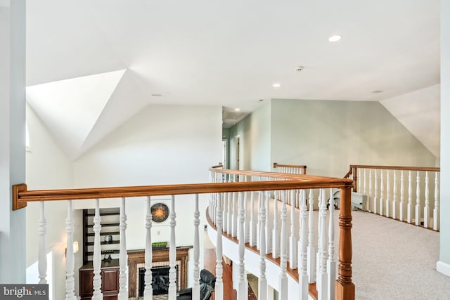 interior space with carpet floors and vaulted ceiling