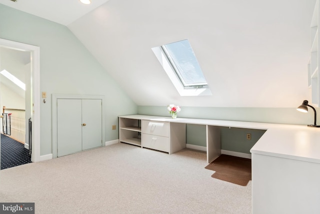 unfurnished office featuring lofted ceiling and light colored carpet