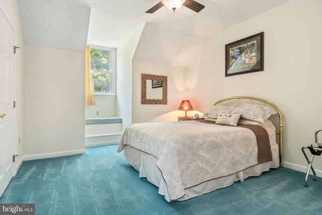 carpeted bedroom with vaulted ceiling and ceiling fan