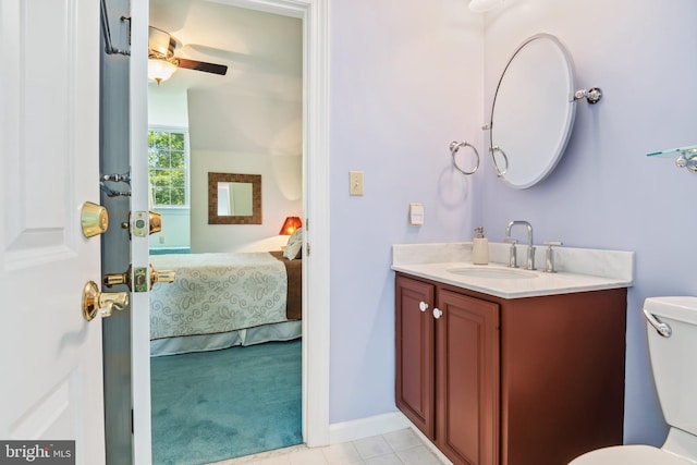 bathroom featuring toilet, vanity, tile patterned floors, and ceiling fan