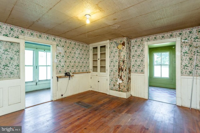 unfurnished dining area featuring dark hardwood / wood-style flooring