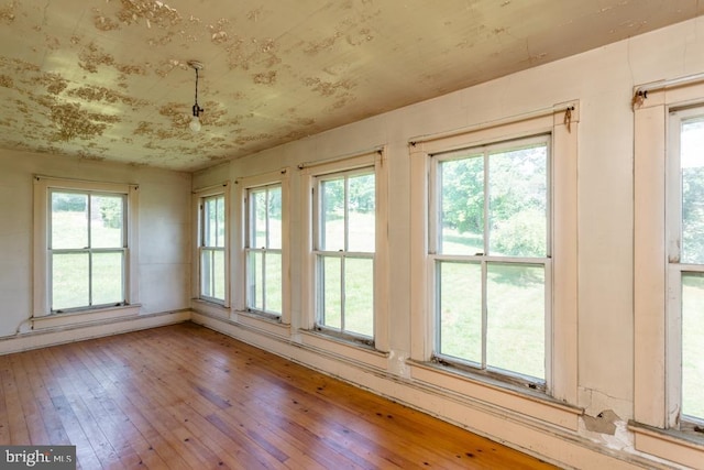 unfurnished sunroom featuring plenty of natural light