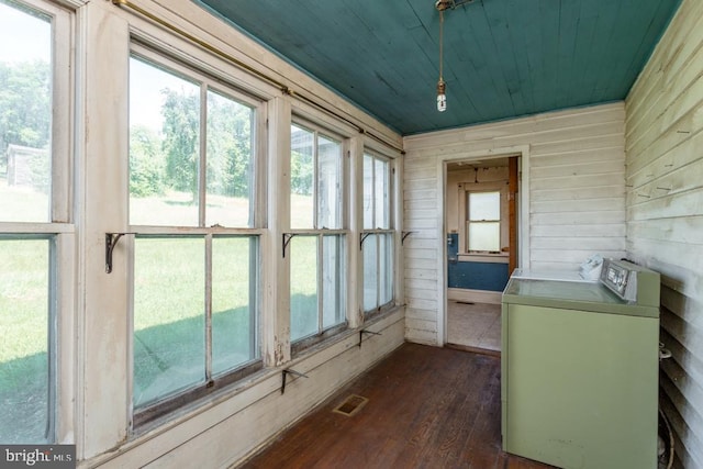 unfurnished sunroom featuring washing machine and clothes dryer