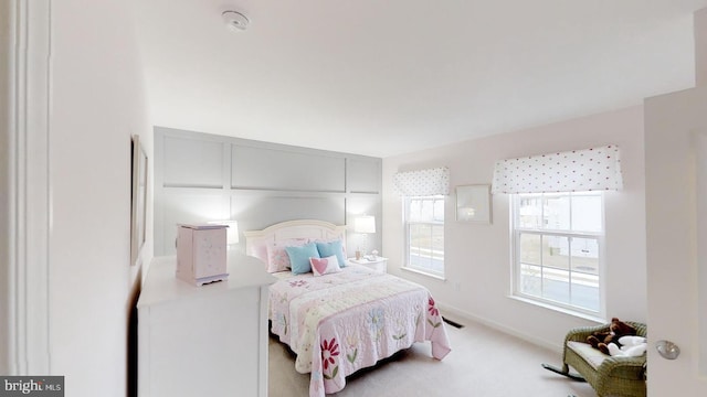 bedroom featuring light colored carpet