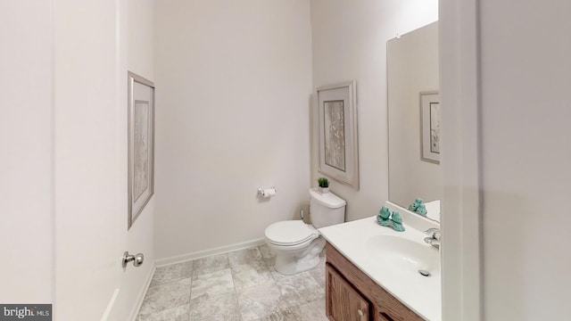 bathroom featuring tile flooring, vanity, and toilet